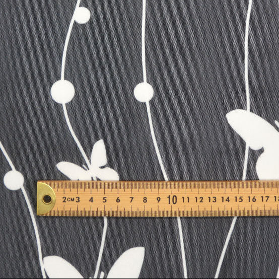 Butterfly pattern on a dark background with a ruler for scale.